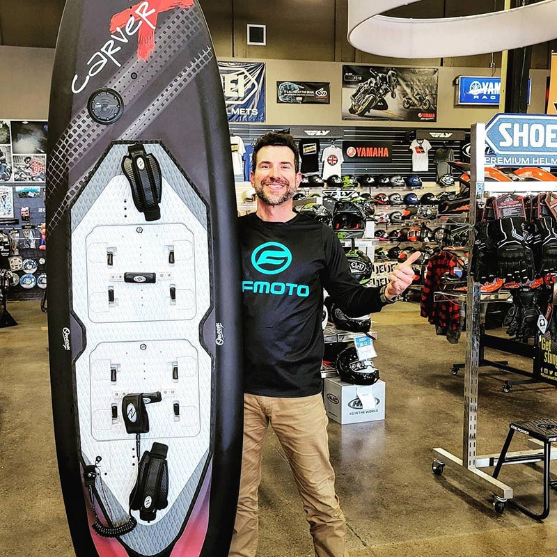 Brent Gyuricza with paddleboard in dealership